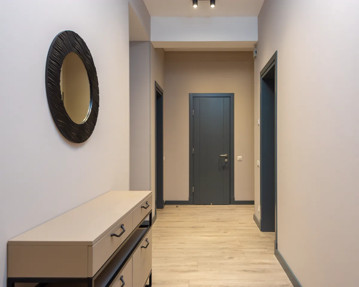 Apartment hallway with interior doors and storage furniture