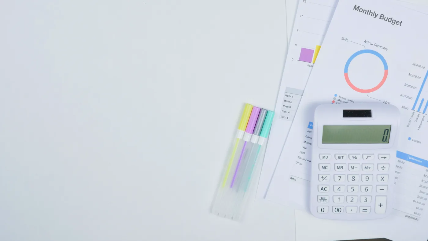 Monthly budget worksheet and calculator on a desk