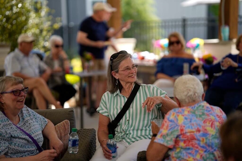 Adults talking together under the pavilion at The Chateau by Highlands
