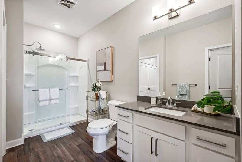 Apartment bathroom with a walk-in shower and quartz vanity