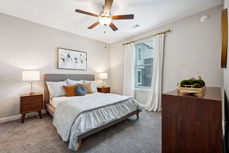 Furnished bedroom in an apartment home at The Chateau by Highlands