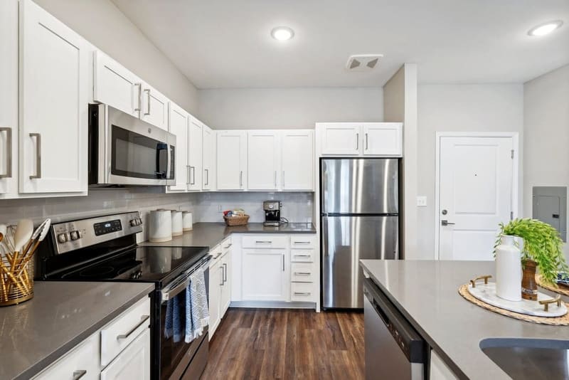 Kitchen island with bar seating in an apartment home at The Chateau by Highlands