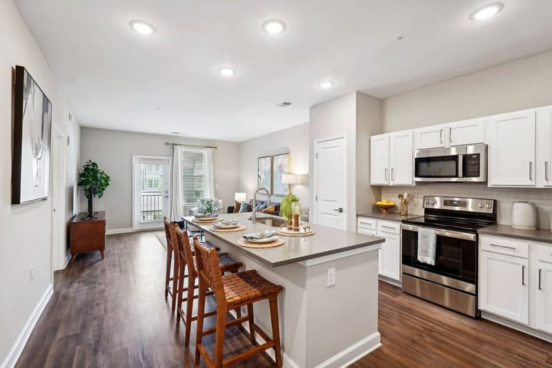 Apartment kitchen showing full-size stainless steel appliances and cabinet storage