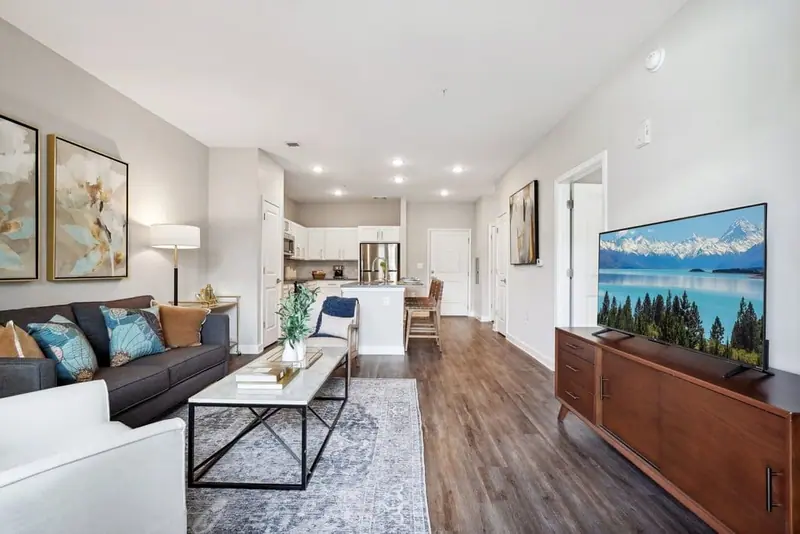 Open living room and kitchen in an apartment at The Chateau by Highlands